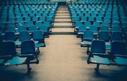 lecture chairs in a class room with stair path in the middle of a class