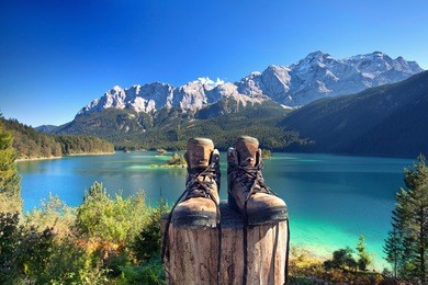 beautiful lake view to eibsee and zugspitze with hiking boots