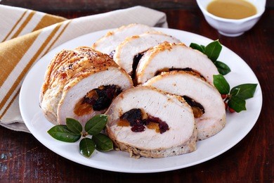 roasted pork loin stuffed with dried fruits for christmas table