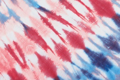 tie dye pattern hand dyed on cotton fabric background.

