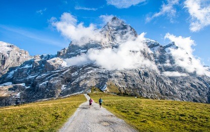 two runners on the pass way to grosse scheidegg above grindelwald, switzerland.