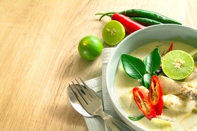 spicy creamy coconut soup with chicken , thai food called tom kha gai on wooden table