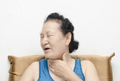 portrait of asian senior woman sore throat expression