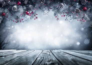 winter background with frost fir branch and wooden planks 