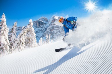skier skiing downhill in high mountains