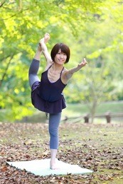 japanese woman doing yoga "lord of the dance pose"