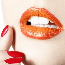 women close up with red orange lips and red nails
