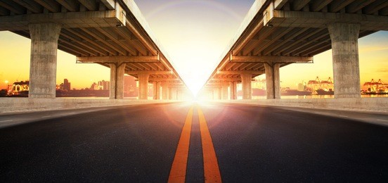 sun rising behind perspective on bridge ram for land transport and civil development 