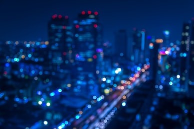 defocused urban abstract texture -blurred background with bokeh of city lights from car on street at night