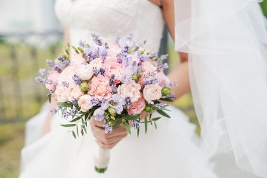 wedding bouquet of lavender, roses and peonies.  bride with a bouquet of flowers.