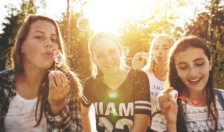 closeup of group of teenagers outside on a summer day