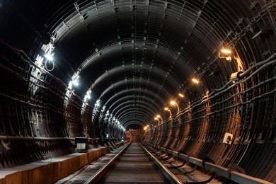 straight circular subway tunnel with tubing and two different lights: white and yellow