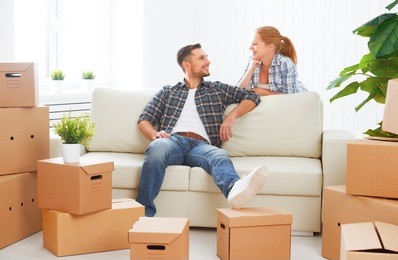 moving to a new apartment. happy family couple and a lot of cardboard boxes.
