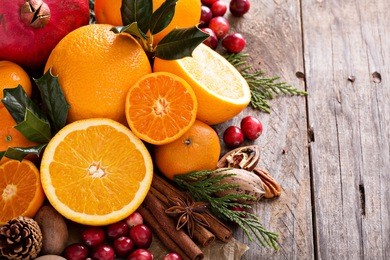 fall and winter ingredients still life with oranges, cranberry, nuts and spices