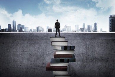 back view business person looking the city, standing on the top of the book. education for success concept