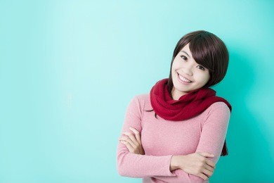young beautiful woman wearing winter clothing and smile to you isolated on green background, asian beauty