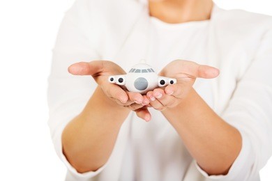 businesswoman hands holding a toy plane.