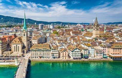 aerial view of zurich city center with famous st. peter church and river limmat at lake zurich from grossmunster church on a sunny day with blue sky and clouds in summer, canton of zurich, switzerland