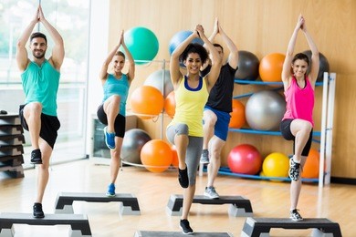 fitness class exercising in the studio at the gym