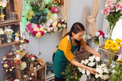 asian young woman working in flower shop