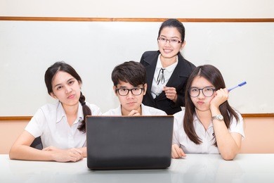 asian student and teacher in classroom