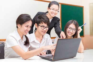 asian student and teacher in classroom