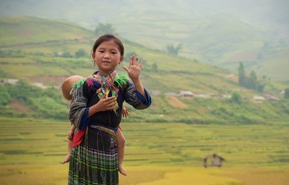 woman from black hmong hill tribe, children girl smile,tu le lao cai,vietnam.