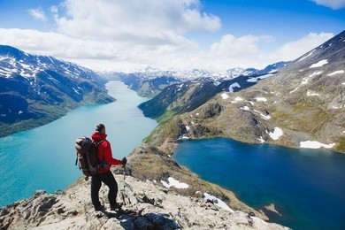 traveler with backpack and mountain panorama. norway