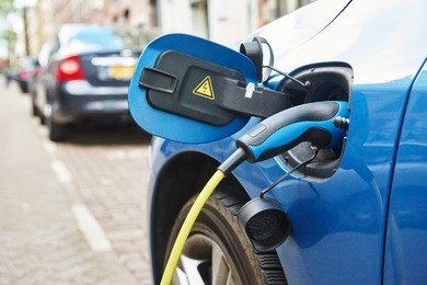 alternative eco energy fuel. close up of the power supply plugged into an electric car during charging in amsterdam