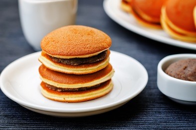 dorayaki, japanese red bean pancakes on a black background. toning. selective focus