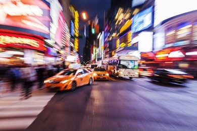 picture with creative zoom effect made by camera of cars and yellow cabs in manhattan, new york city, at night