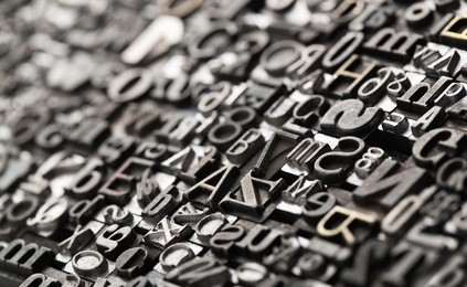 letterpress background, close up of many old, random metal letters with copy space