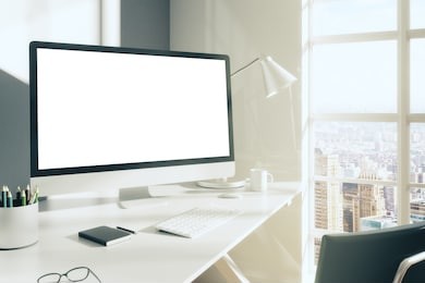 blank computer desktop with keyboard, diary and other accesories on white table in sunny room, mock up
