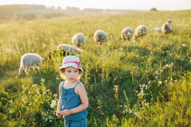 portrait of a little girl walking in the field
