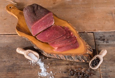 dried meat on wooden background