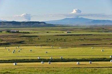 rural landscape with steaming eyjafjallajokull, iceland