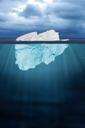 half seen iceberg floating in ocean 
