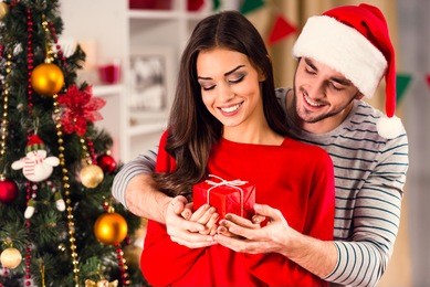 merry christmas. young couple celebrating christmas at home