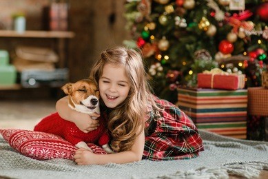 happy little girl and dog at christmas