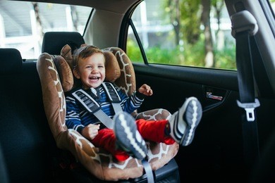 adorable baby boy in safety car seat. 