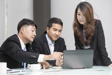 asian business, technology and office concept - strict female boss talking to business team.