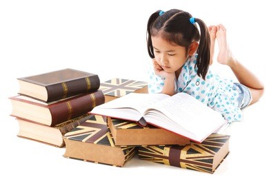 asian cute girl reading book while lay down on floor. white background