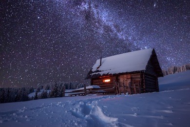 wooden house in winter forest
