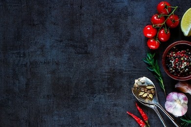 vintage spoon and vegetables for cooking on dark metal background with space for text. top view. bio healthy food ingredients. 