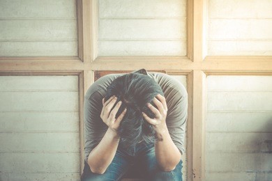 anxious asian man sitting on the chair , process in vintage style