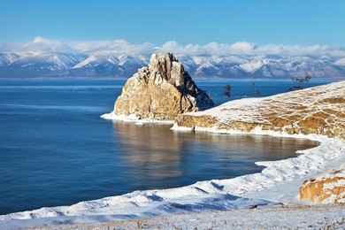 baikal lake in december. shamanka rock and beach bay in the snow