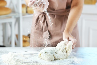 making dough by female hands at bakery