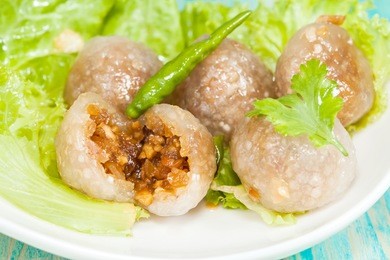 tapioca balls with pork filling and paprika on lettuce