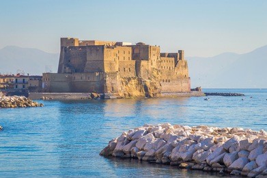 castel dell'ovo (italian for the "egg fortress") in the port of naples in italy, with the gulf of naples