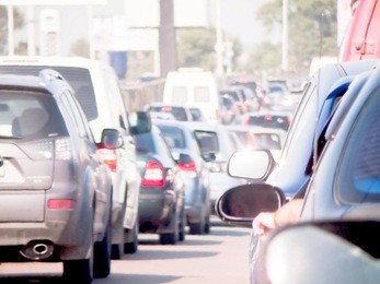 cars line up against a detour caused by a fatal accident on the highway during rush hour